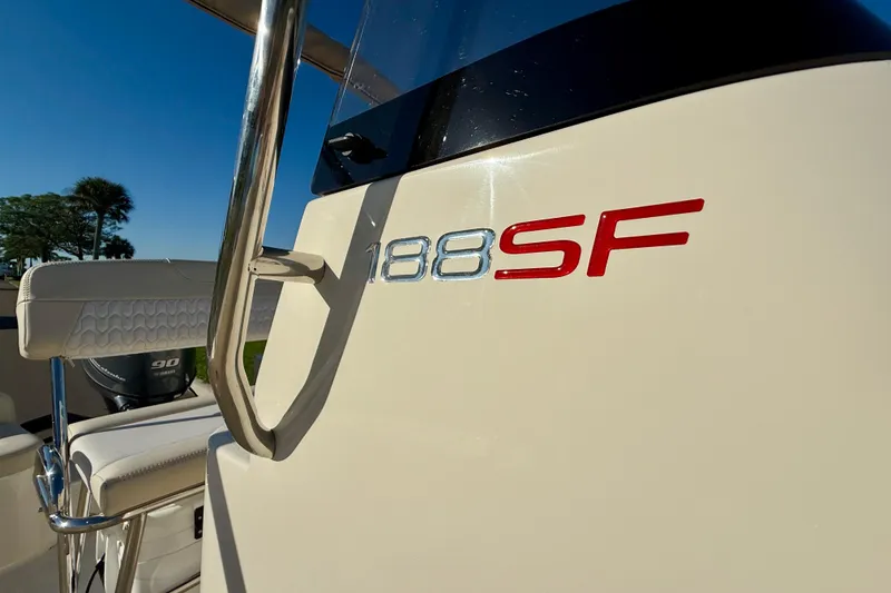Slide: The Image of 2026 Scout 188 Sportfish boat with logo detail in sunlight. - 13