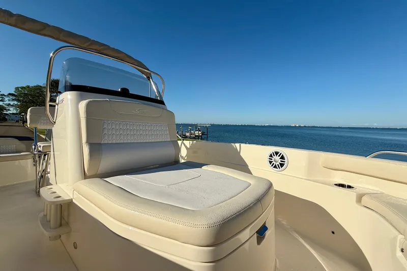 Slide: The Image of 2026 Scout 188 Sportfish boat interior with seating, overlooking a serene ocean view. - 14