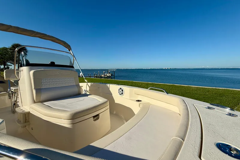 Slide: The Image of 2026 Scout 188 Sportfish boat interior with seating, overlooking a serene waterfront view. - 15
