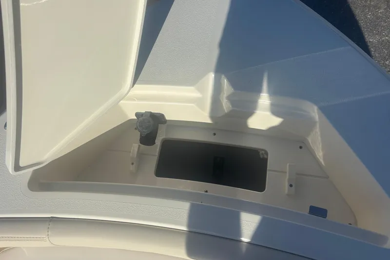 Slide: The Image of Open storage compartment on 2026 Scout 188 Sportfish boat, showcasing interior space. - 16