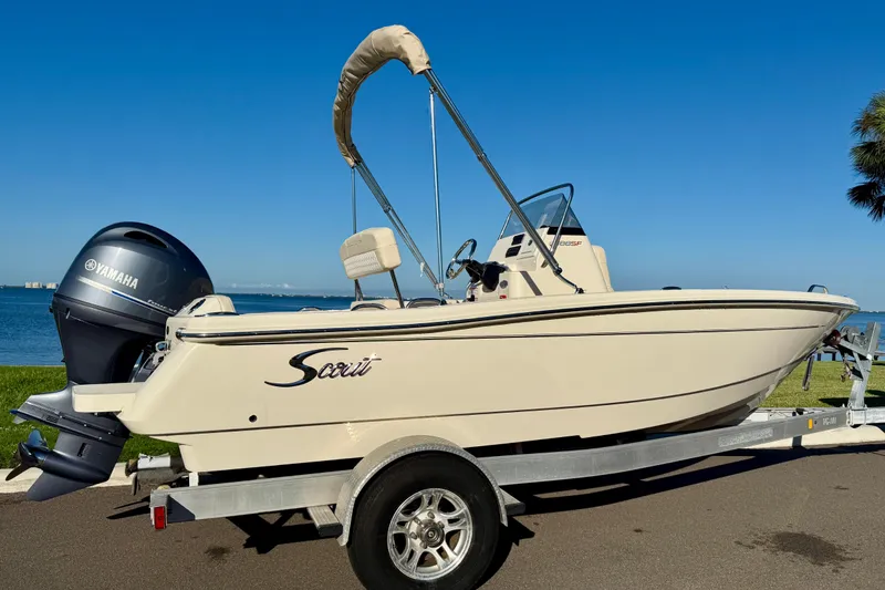 Slide: The Image of 2026 Scout 188 Sportfish boat on trailer with Yamaha outboard motor, near waterfront. - 3