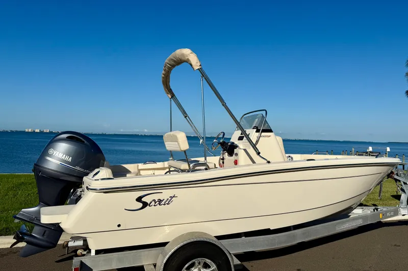 Slide: The Image of 2026 Scout 188 Sportfish boat with Yamaha engine by the water. - 4