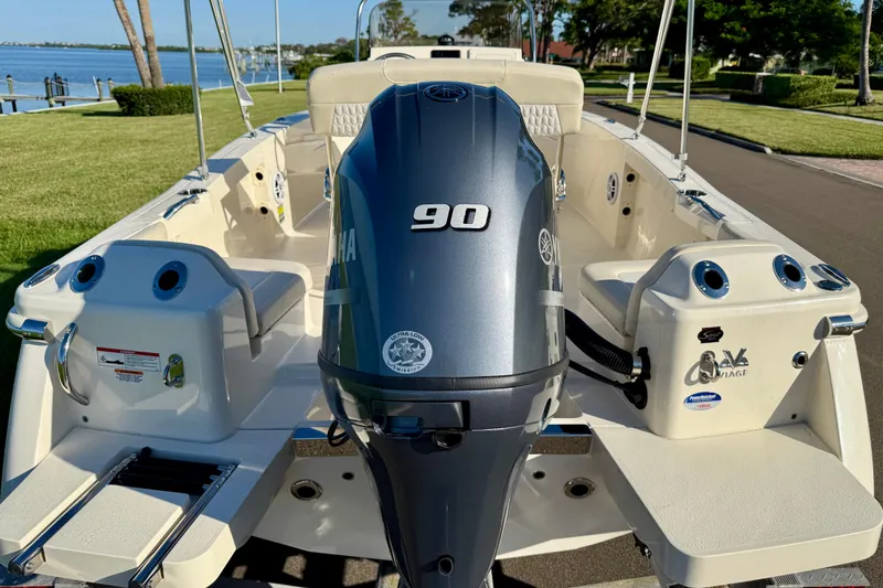 Slide: The Image of 2026 Scout 188 Sportfish boat with Yamaha 90 engine, docked near a scenic waterfront. - 5