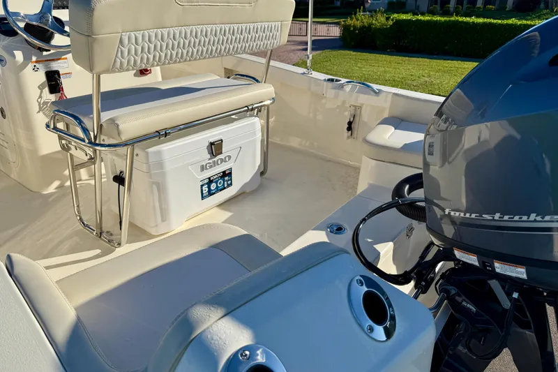 Slide: The Image of 2026 Scout 188 Sportfish boat interior with seating, cooler, and four-stroke engine. - 8