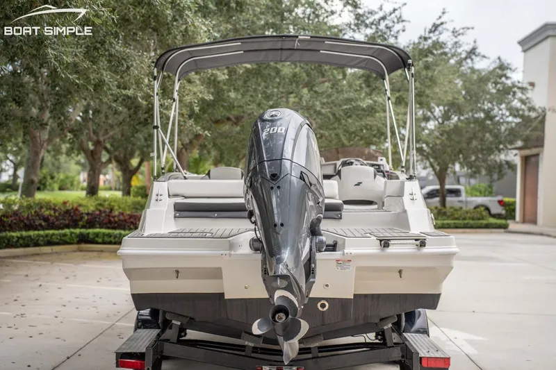 Slide: The Image of 2023 Starcraft SVX 231 OB DH boat with outboard motor, parked on a trailer. - 3
