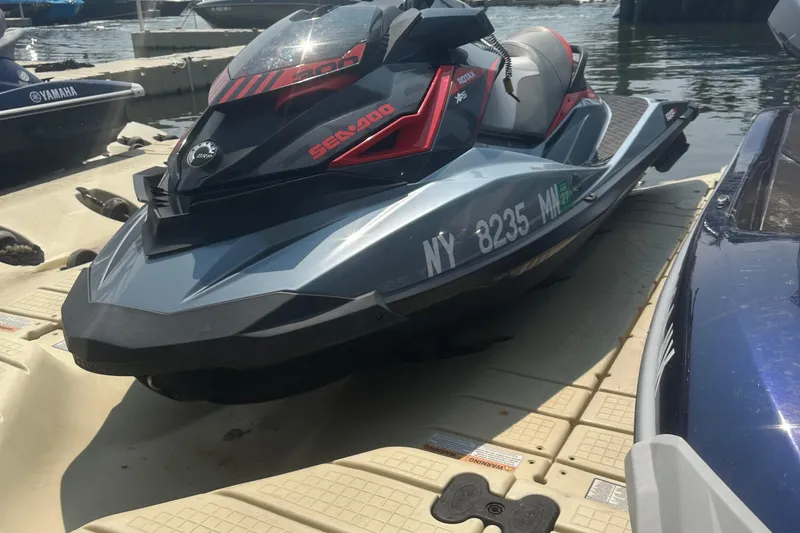 Slide: The Image of 2018 Sea-Doo RXP-X 300 jet ski docked at marina, side view. - 3