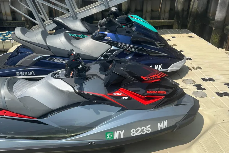 Slide: The Image of 2018 Sea-Doo RXP-X 300 jet ski docked alongside Yamaha WaveRunners. - 4