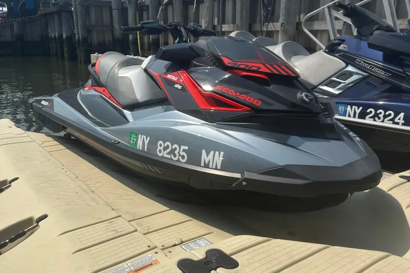 Slide: The Image of 2018 Sea-Doo RXP-X 300 jet ski docked, featuring sleek design and vibrant colors. - 6
