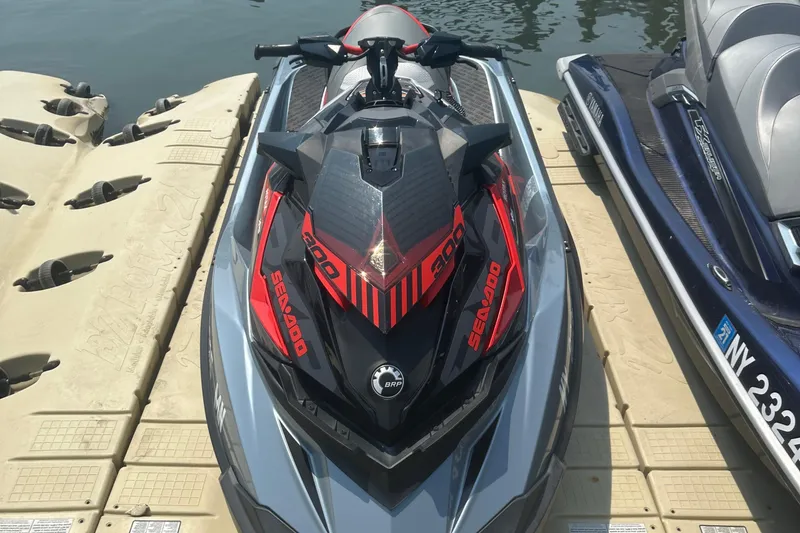 Slide: The Image of 2018 Sea-Doo RXP-X 300 jet ski docked on a floating platform. - 9