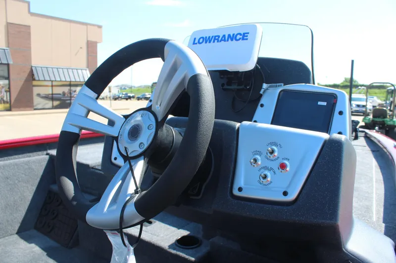 Slide: The Image of 2026 Tracker Pro Team 195 boat dashboard with steering wheel and Lowrance electronics. - 10