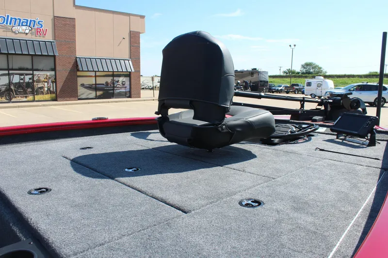 Slide: The Image of 2026 Tracker Pro Team 195 boat deck with seating, parked near RV dealership. - 12