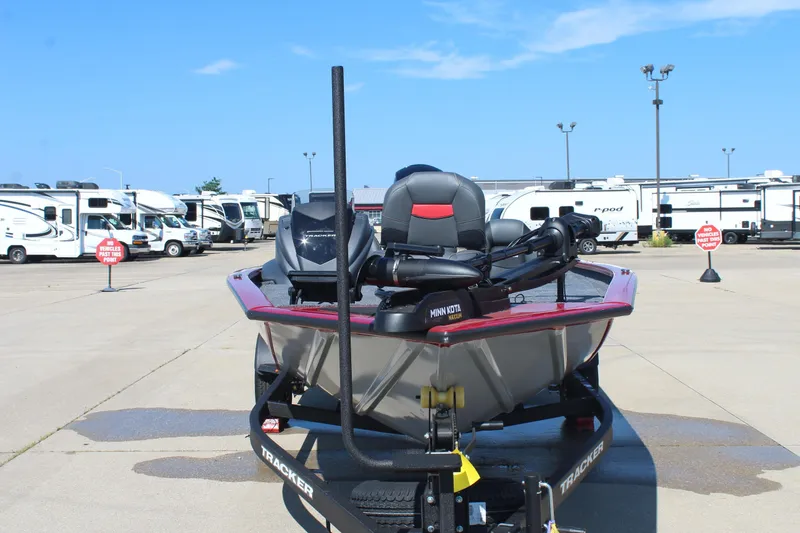 Slide: The Image of 2026 Tracker Pro Team 195 boat on trailer, parked in RV lot under clear sky. - 3