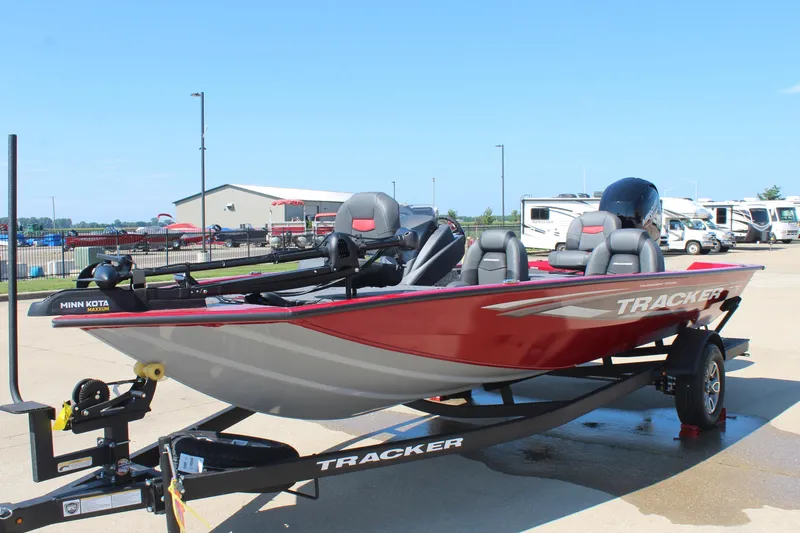 Slide: The Image of 2026 Tracker Pro Team 195 boat, red exterior, on trailer in outdoor setting. - 4