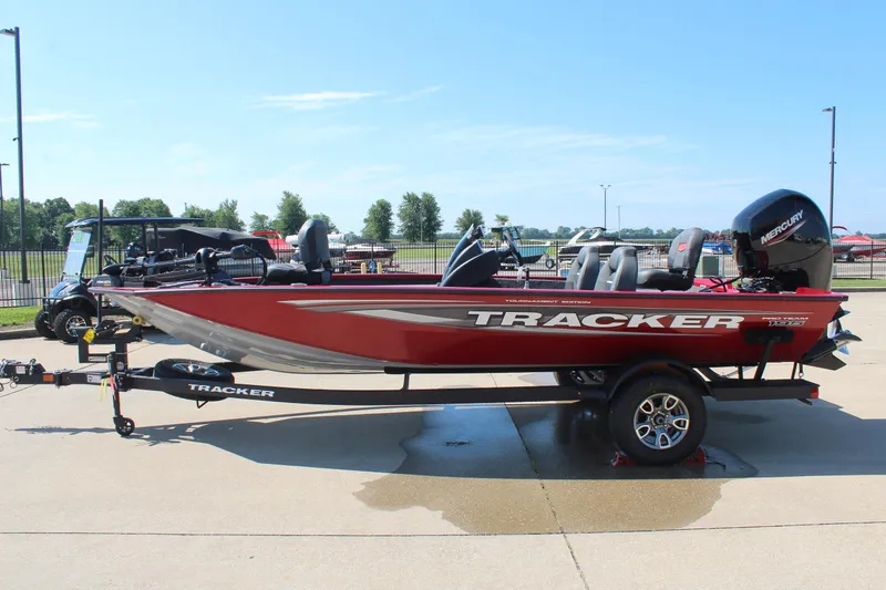 Slide: The Image of 2026 Tracker Pro Team 195 boat on trailer, red exterior, parked outdoors. - 5