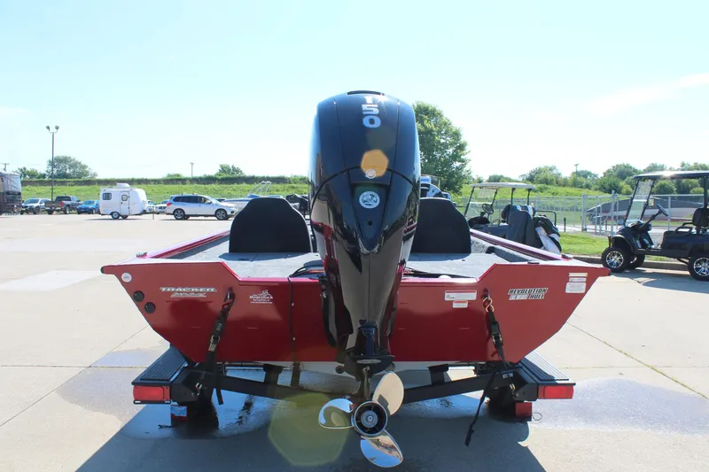 Slide: The Image of 2026 Tracker Pro Team 195 boat with powerful outboard motor in a parking lot. - 7