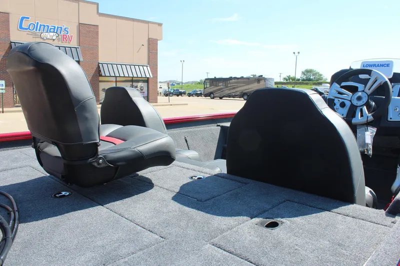 Slide: The Image of 2026 Tracker Pro Team 195 boat interior with seats and steering wheel, parked near Colman's RV. - 9