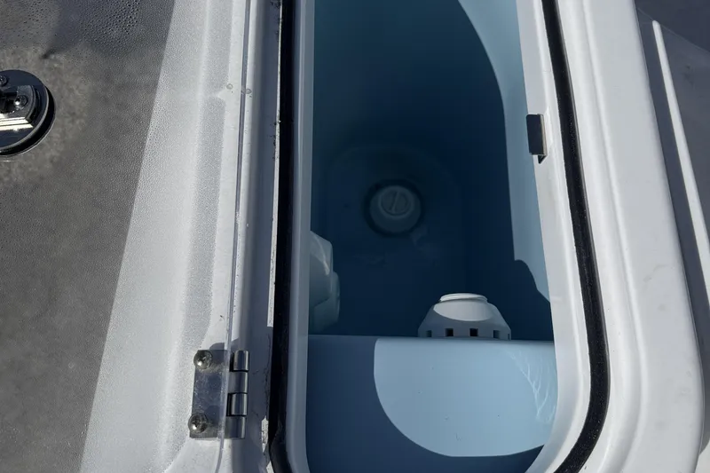 Slide: The Image of Livewell compartment on 2025 Wellcraft 242 Fisherman boat, open lid view. - 11