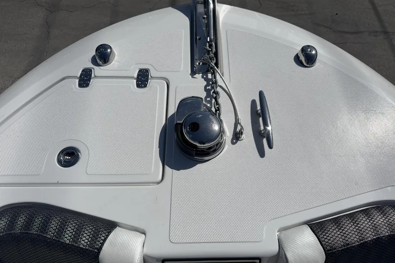 Slide: The Image of Bow of 2025 Wellcraft 242 Fisherman boat with anchor and storage compartments. - 15