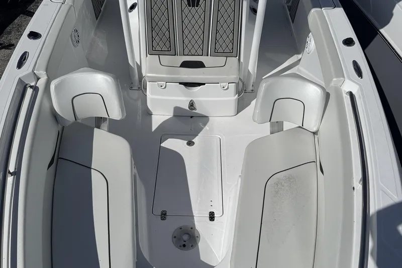 Slide: The Image of 2025 Wellcraft 242 Fisherman boat interior with white seating and storage compartments. - 17