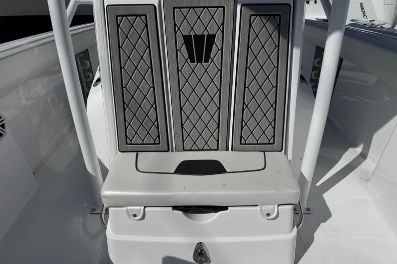 Slide: The Image of 2025 Wellcraft 242 Fisherman boat interior with cushioned seating and storage compartment. - 18