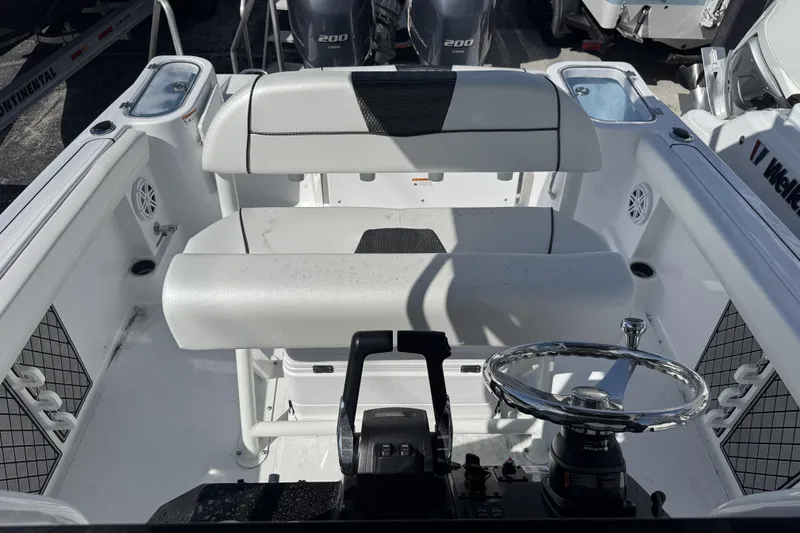 Slide: The Image of 2025 Wellcraft 242 Fisherman boat interior with dual seating and steering wheel. - 19