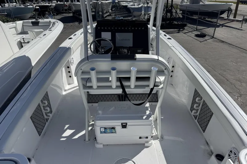 Slide: The Image of 2025 Wellcraft 242 Fisherman boat interior with steering console and rod holders. - 5