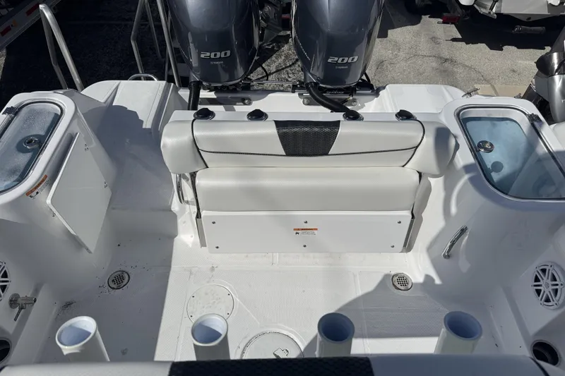 Slide: The Image of 2025 Wellcraft 242 Fisherman boat interior with dual 200 engines and seating area. - 8