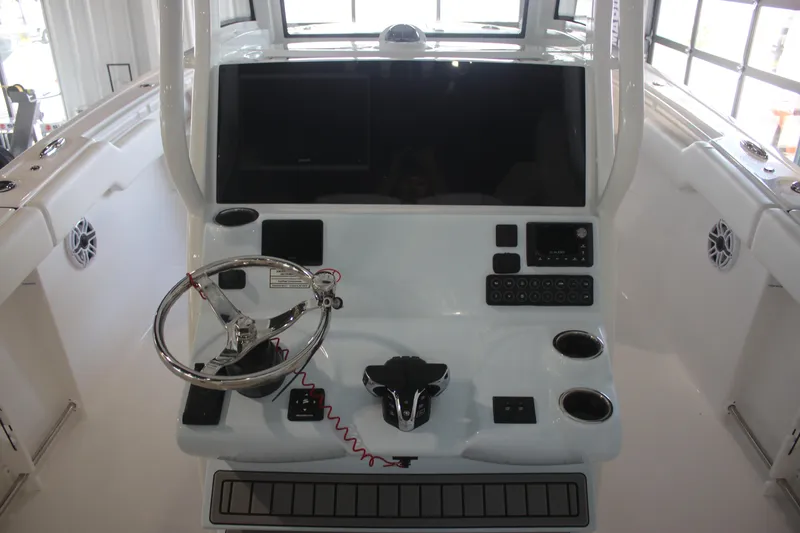 Slide: The Image of 2026 Tidewater 282 CC Adventure boat helm with steering wheel and control panel. - 11