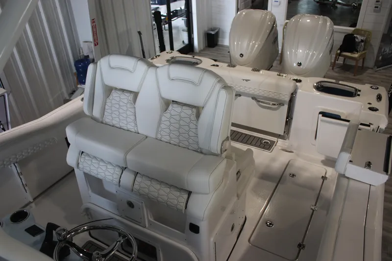 Slide: The Image of 2026 Tidewater 282 CC Adventure boat interior with dual seats and twin engines. - 15
