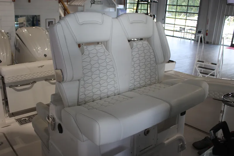 Slide: The Image of 2026 Tidewater 282 CC Adventure boat interior with luxurious white seating. - 16