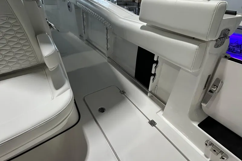 Slide: The Image of 2026 Tidewater 282 CC Adventure boat interior with white seating and sleek design. - 4