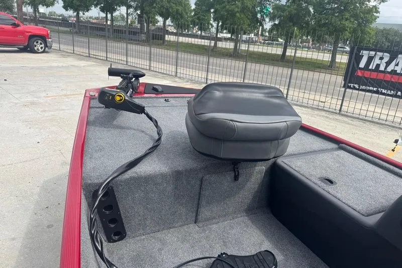 Slide: The Image of 2024 Bass Tracker Classic XL boat interior with seating and controls. - 10