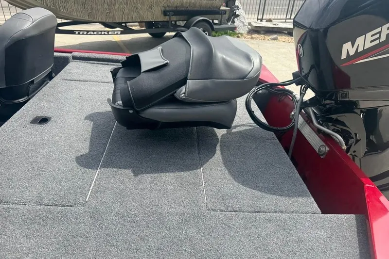 Slide: The Image of 2024 Bass Tracker Classic XL boat interior with motor and seating. - 12