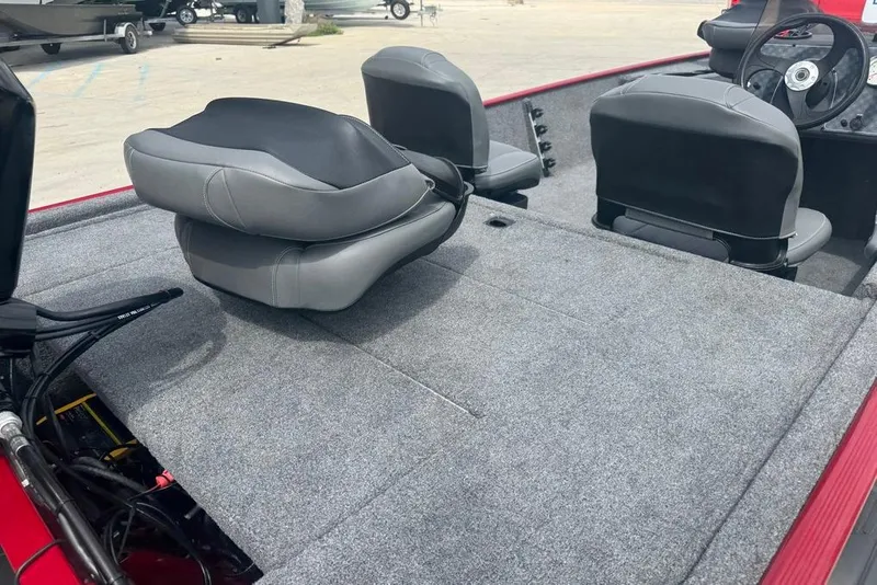 Slide: The Image of 2024 Bass Tracker Classic XL boat interior with gray seating and carpeted deck. - 13