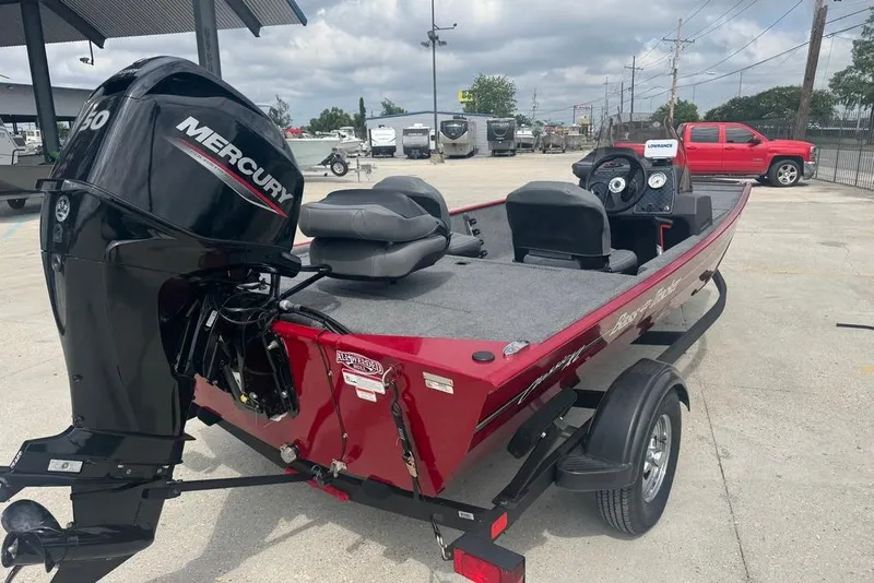 Slide: The Image of 2024 Bass Tracker Classic XL boat with Mercury engine, parked outdoors. - 4