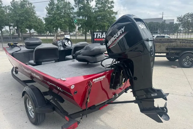 Slide: The Image of 2024 Bass Tracker Classic XL boat with Mercury engine, parked on a trailer. - 6