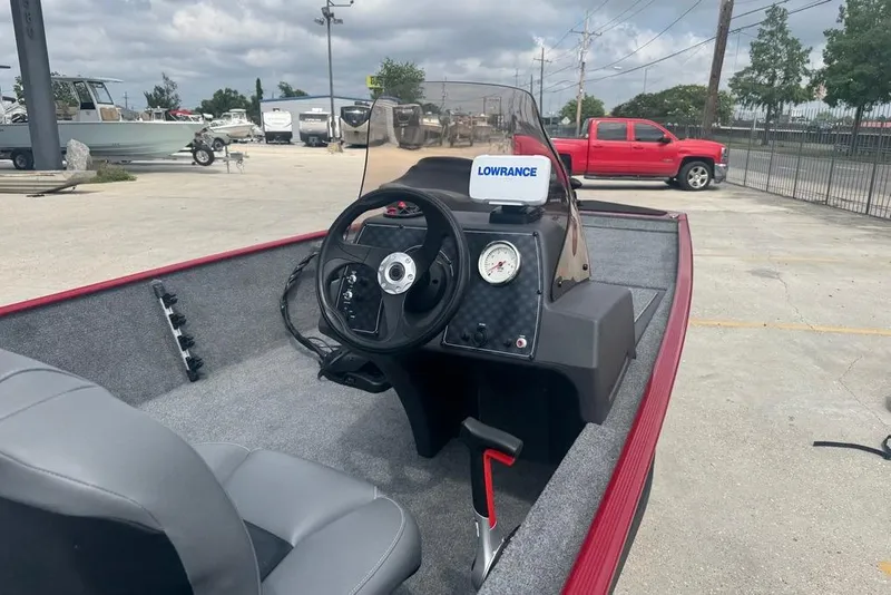 Slide: The Image of 2024 Bass Tracker Classic XL boat interior with steering wheel and Lowrance device. - 14