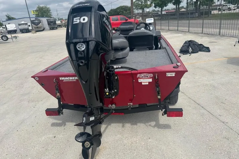Slide: The Image of 2024 Bass Tracker Classic XL boat with Mercury 50 engine, parked outdoors. - 5