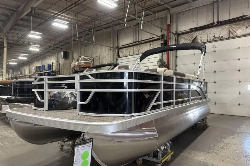 Slide: The Image of 2025 Bennington 21 SF pontoon boat in a warehouse setting. - 3