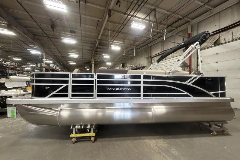 Slide: The Image of 2025 Bennington 21 SF pontoon boat in a warehouse setting. - 4