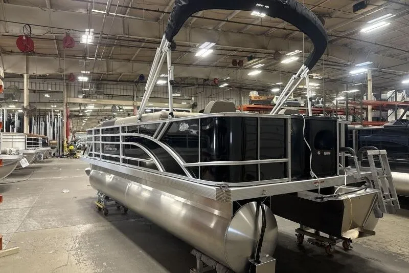 Slide: The Image of 2025 Bennington 21 SF pontoon boat in a factory setting, showcasing sleek design. - 5