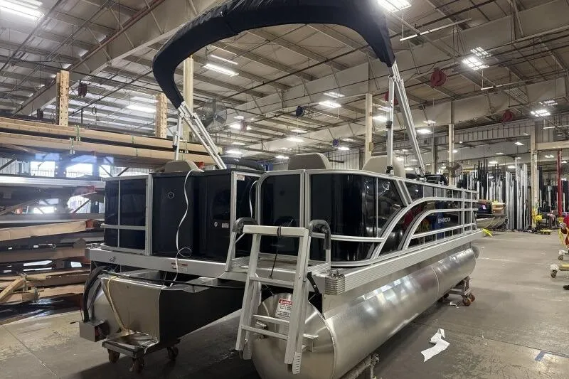 Slide: The Image of 2025 Bennington 21 SF pontoon boat in a warehouse setting. - 6