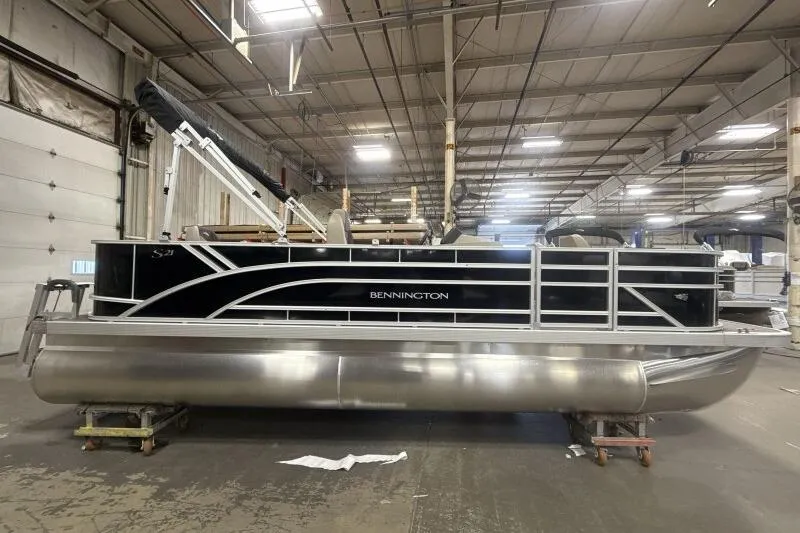 Slide: The Image of 2025 Bennington 21 SF pontoon boat in a warehouse setting. - 7