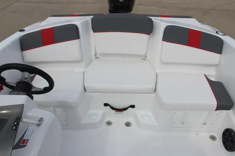 Slide: The Image of 2026 Tahoe T16 boat interior with white and gray seating, red accents, and steering wheel. - 14