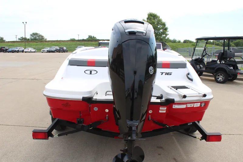 Slide: The Image of 2026 Tahoe T16 boat with outboard motor, parked on a trailer in a lot. - 6