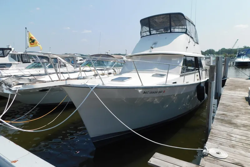 The Image of 1987 Mainship 40 DC yacht docked at marina, featuring sleek design and spacious deck. - 1