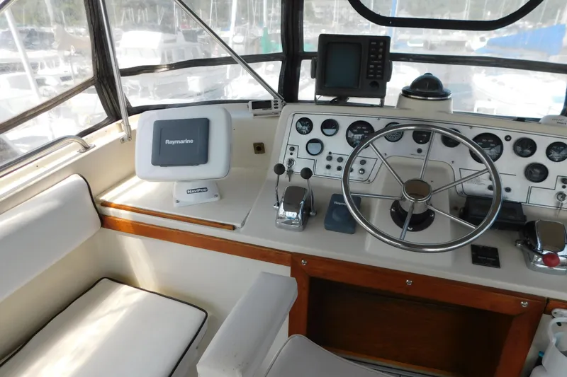 Slide: The Image of 1987 Mainship 40 DC helm with steering wheel, navigation equipment, and control panel. - 10