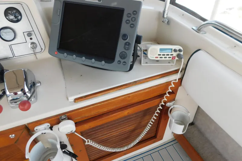 Slide: The Image of 1987 Mainship 40 DC boat dashboard with navigation equipment and controls. - 16