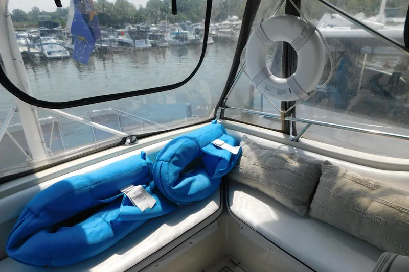 Slide: The Image of 1987 Mainship 40 DC boat interior with blue life jackets and life preserver. - 18