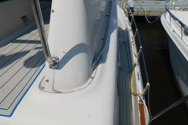 Slide: The Image of 1987 Mainship 40 DC yacht deck with railing and docked boats. - 20